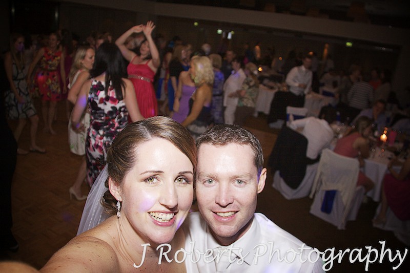 Bride and groom self portrait on dance floor at wedding reception - wedding photography sydney